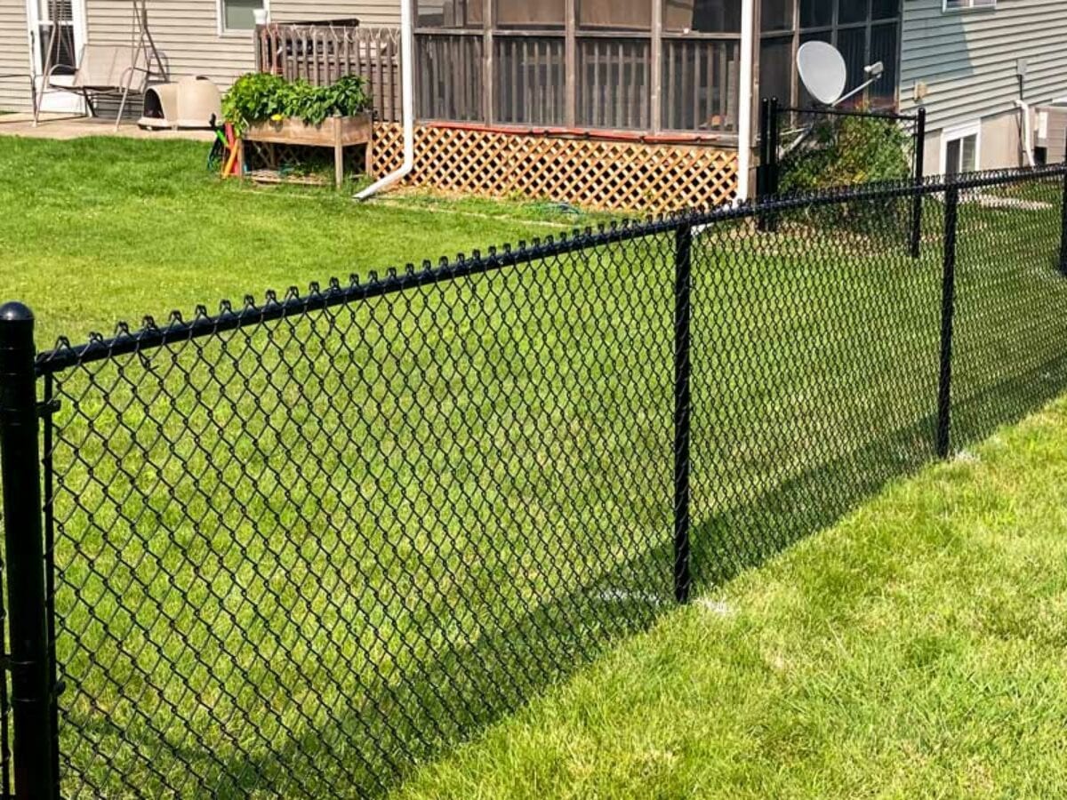Black chain link fence installed in a Fulshear TX backyard