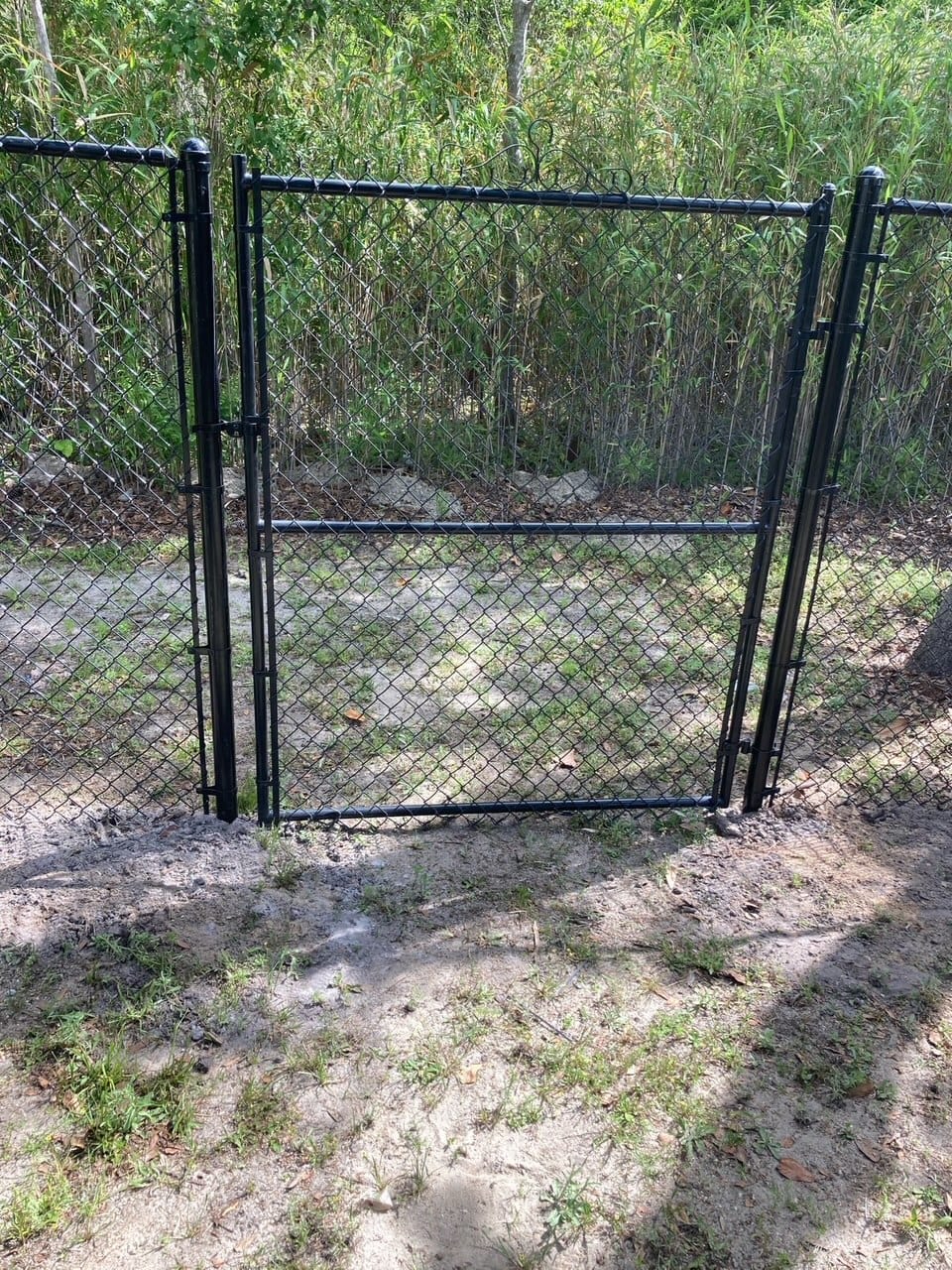 Black chain link gate installation in Fort Bend County TX